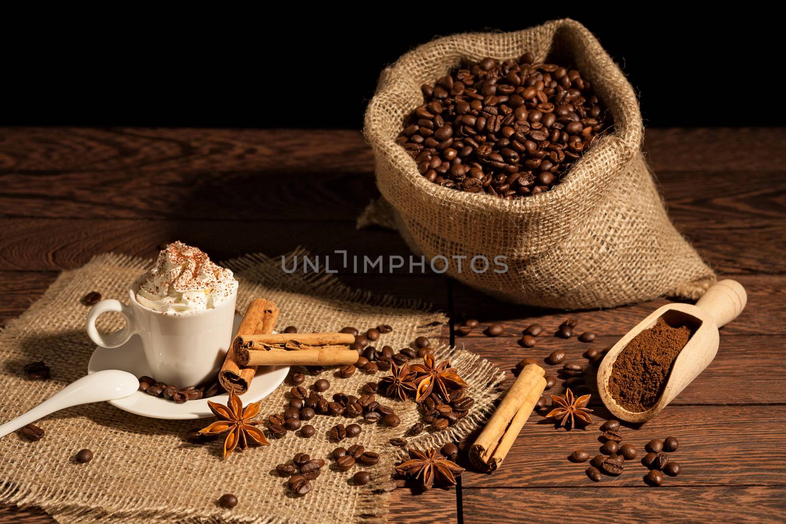 Coffee with whipped cream, cocoa powder, cinnamon and star anise