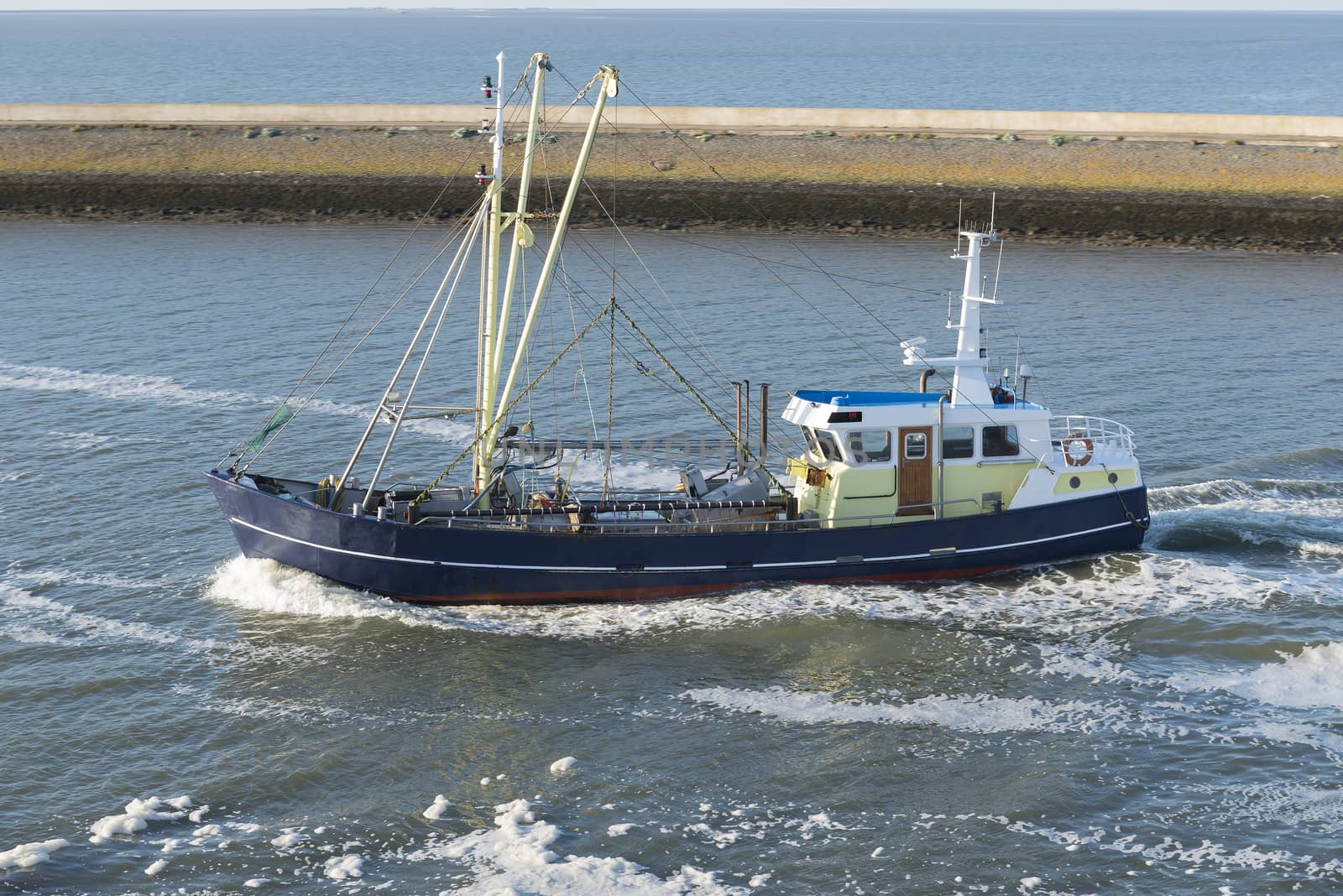 Fishing boat entering the fishing port of Harlingen from the UNESCO protected Wadden Sea in the Netherlands
