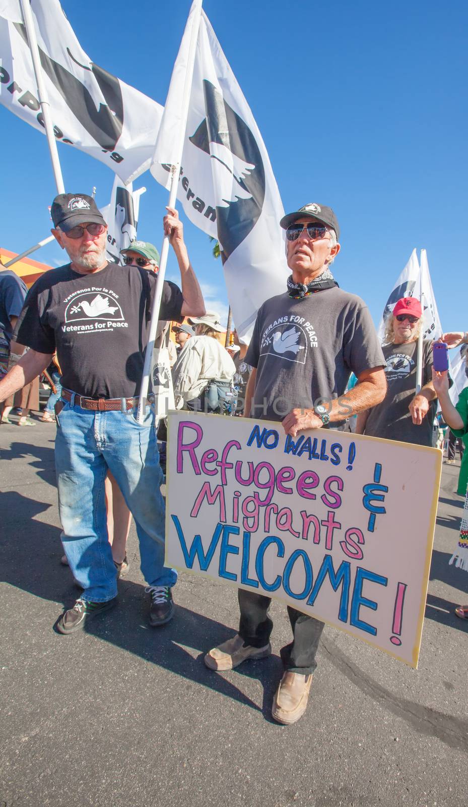 NOGALES, AZ - OCTOBER 08: Group of US war veterans with flags and signs at border policy protest march on October 08, 2016 in Nogales, AZ, USA.