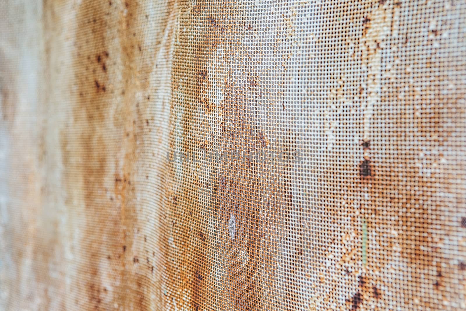 Old rusty mesh in blurring. Colorful pattern. Metal rusty fences.