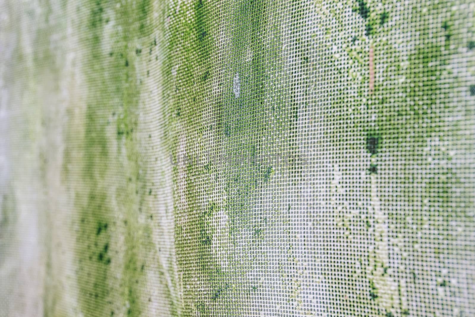 Old rusty mesh in blurring. Colorful pattern. Metal rusty fences.