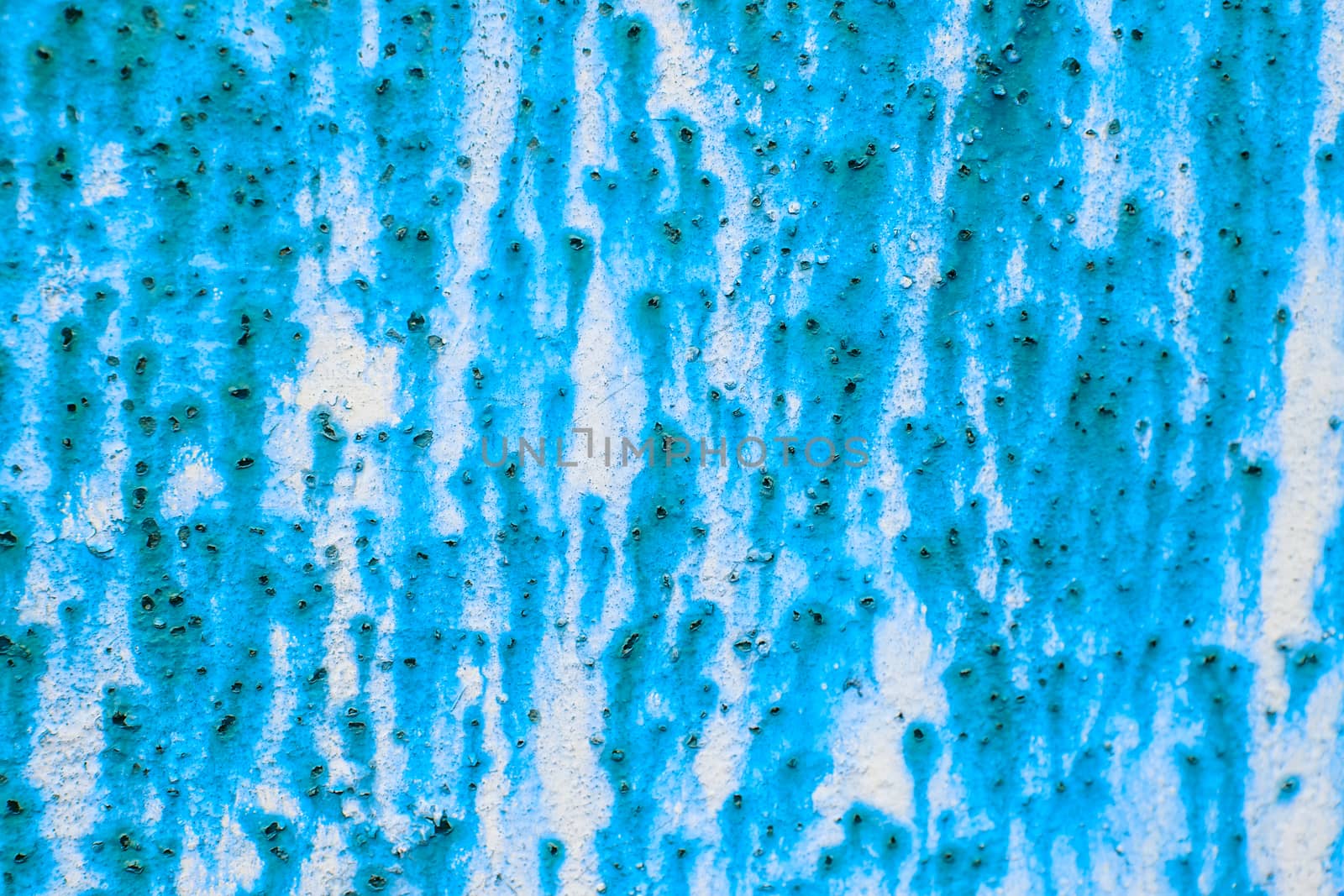 Rusty metal wall background with streaks of rust. Rust stains.