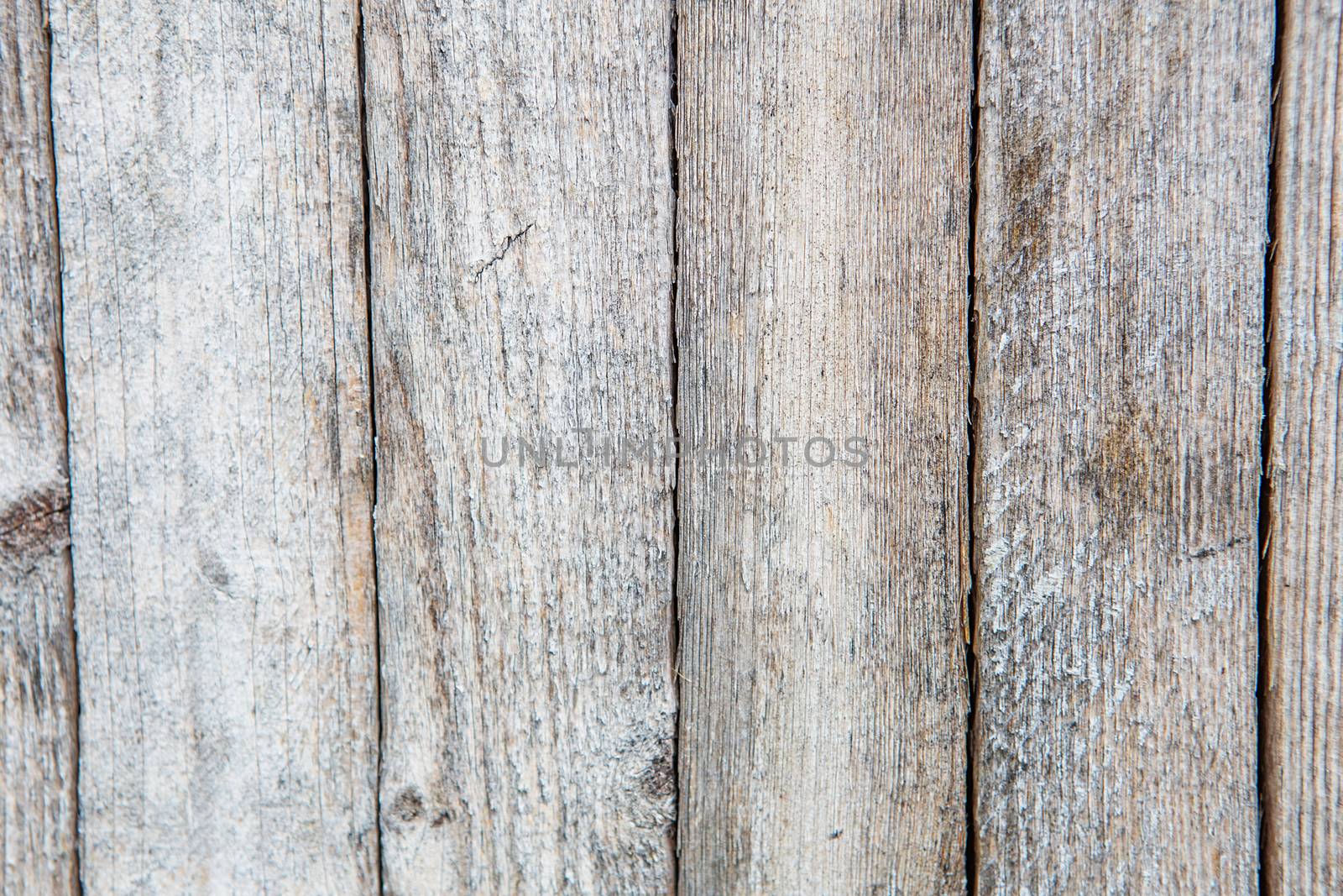 Cracking and peeling paint on a wall. Vintage wood background with peeling paint. Old board with Irradiated paint