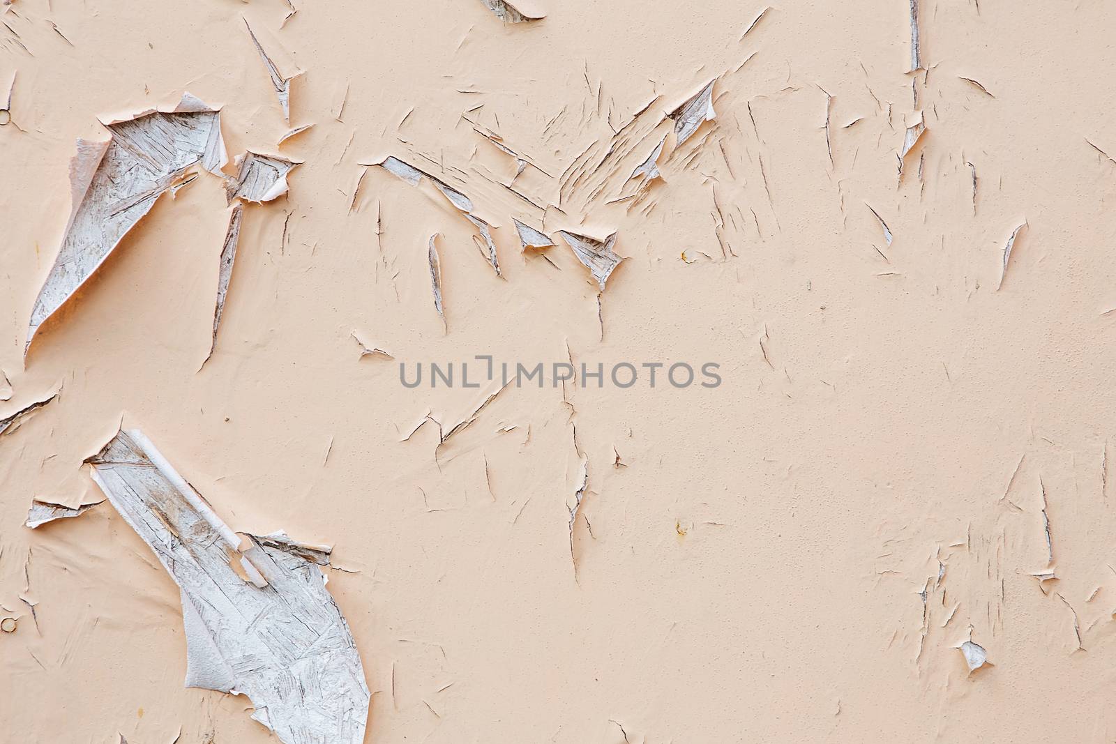 Cracking and peeling paint on a wall. Vintage wood background with peeling paint. Old board with Irradiated paint