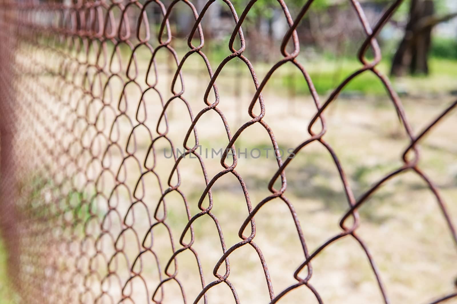 Old rusty mesh in blurring. Colorful pattern. Metal rusty fences.