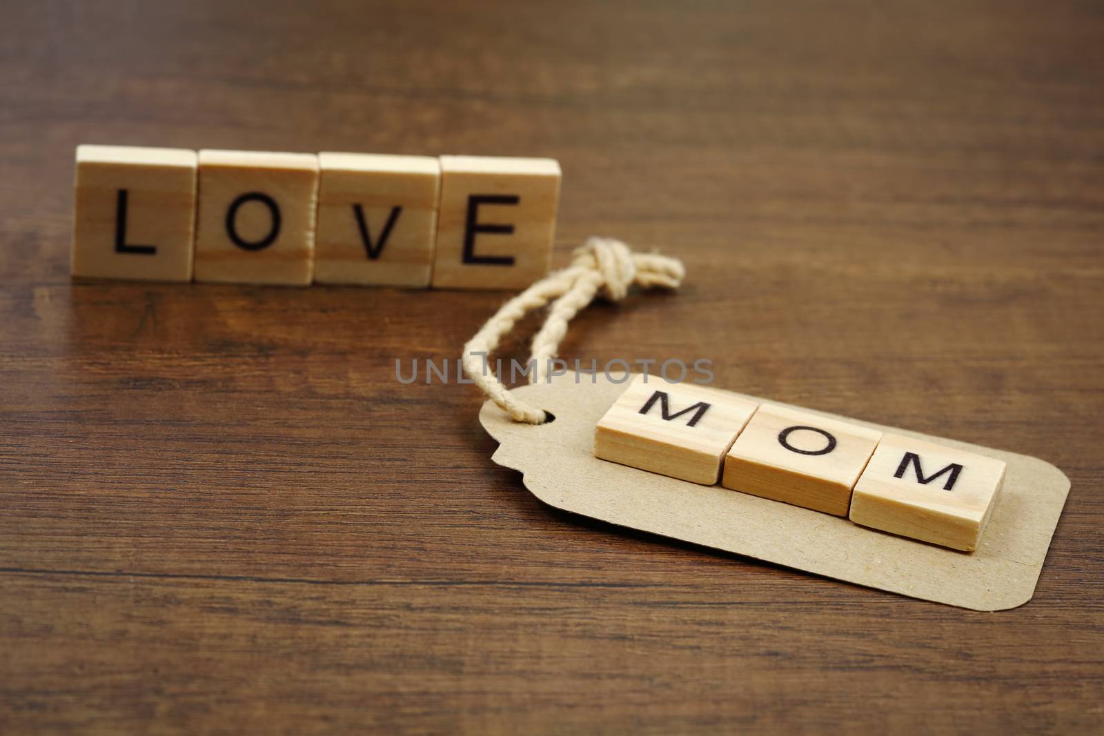 Love mom wording with paper label on wood by phalakon