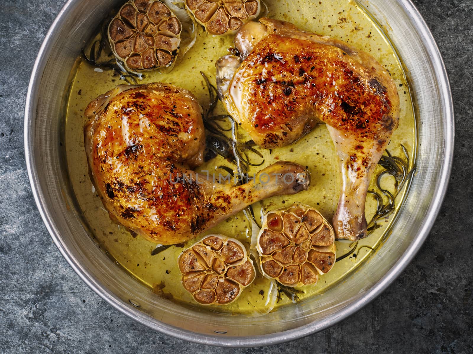 close up of rustic italian roast chicken with garlic and rosemary
