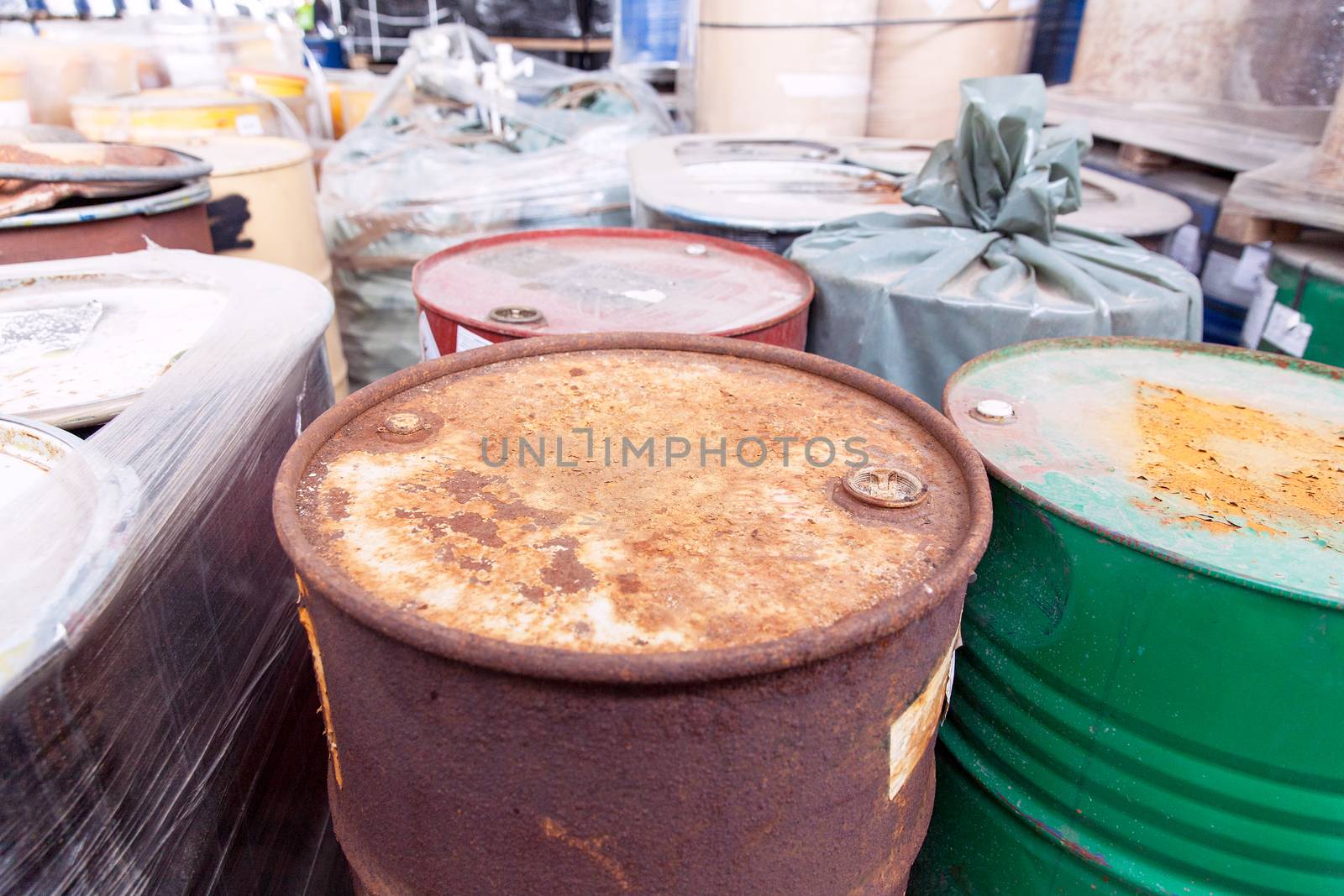 Old, rusty barrels with toxic chemical waste by wellphoto