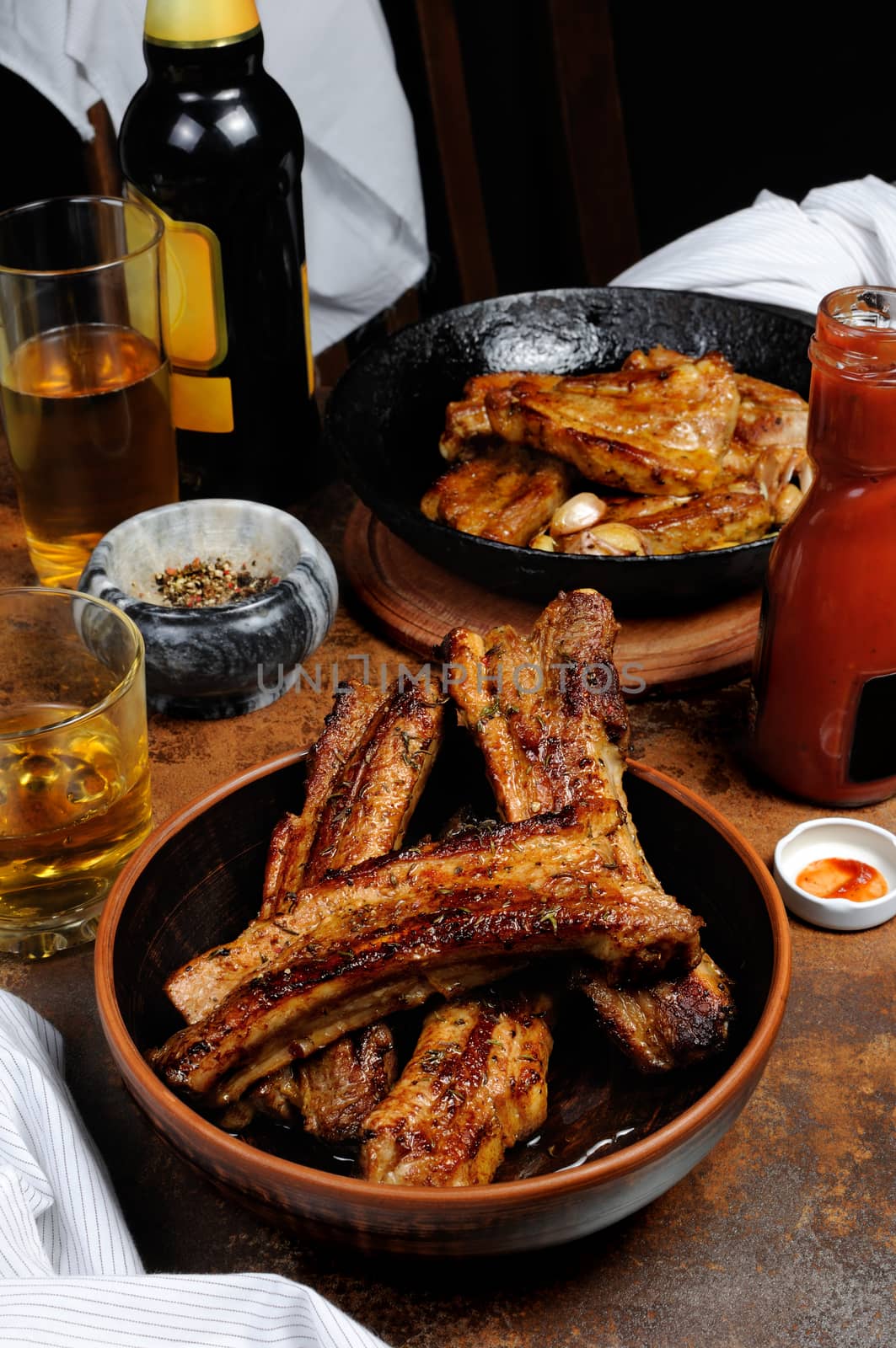 Fried spicy, sharp pork ribs with beer and ketchup. Vertical shot.