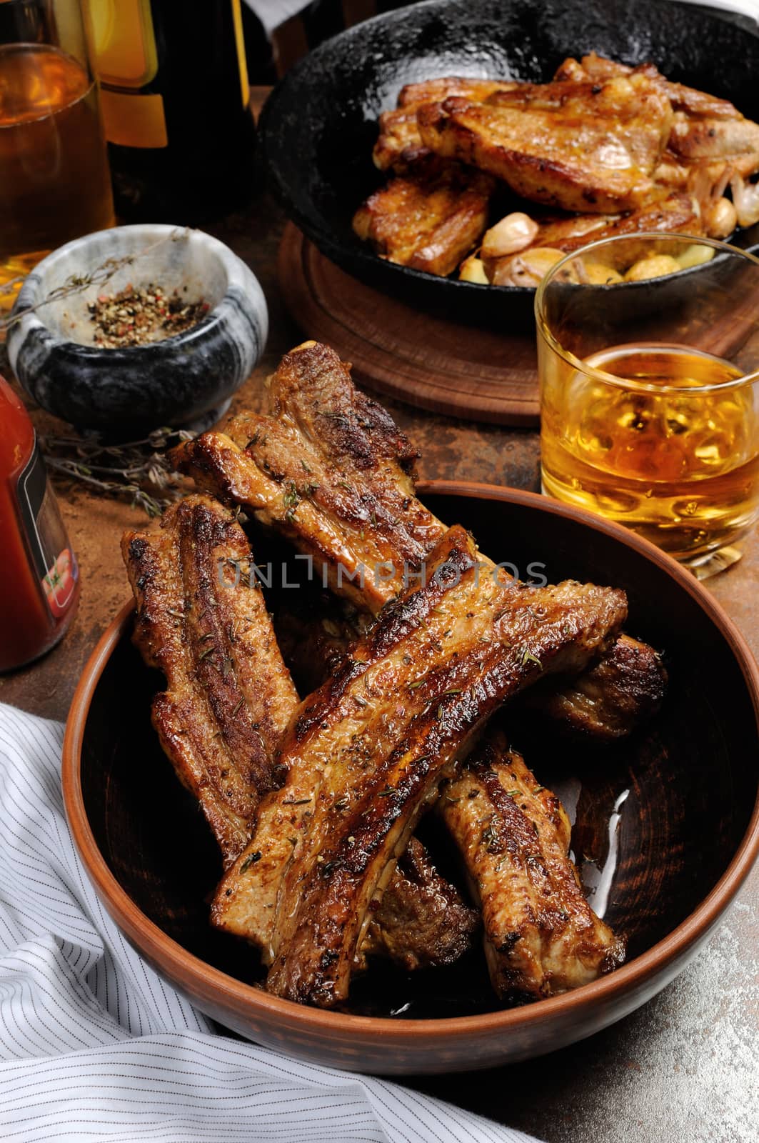 Fried spicy, sharp pork ribs with beer and ketchup. Vertical shot.