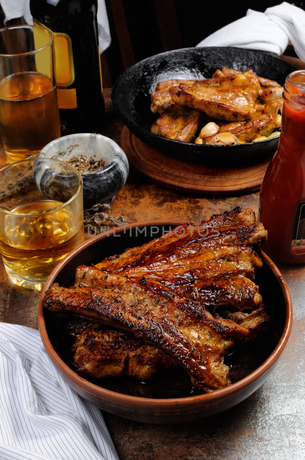 Fried spicy, sharp pork ribs with beer and ketchup. Vertical shot.