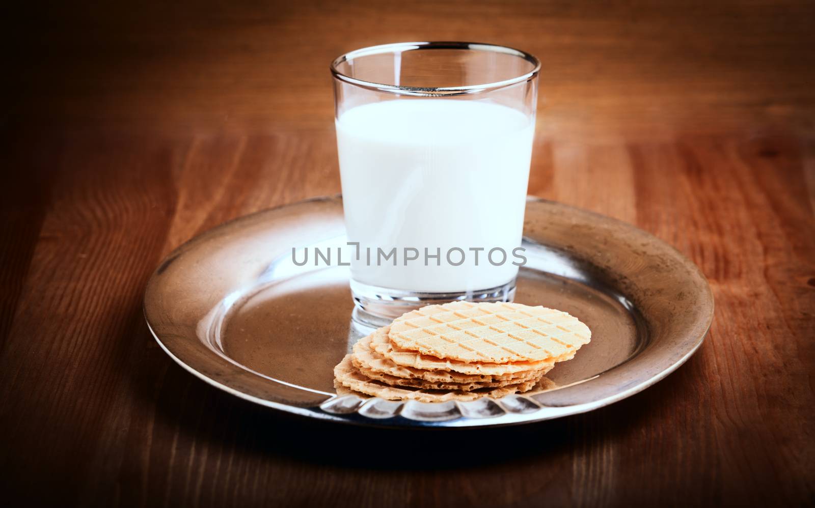 A glass of Milk and crackers served on the table