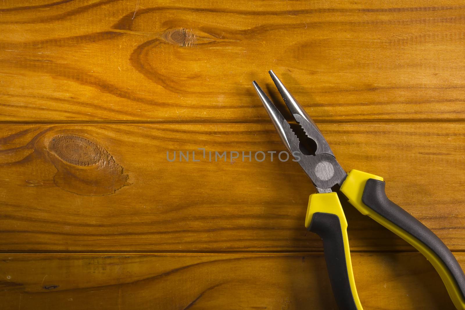 Close up of a multitool pliers on wooden background