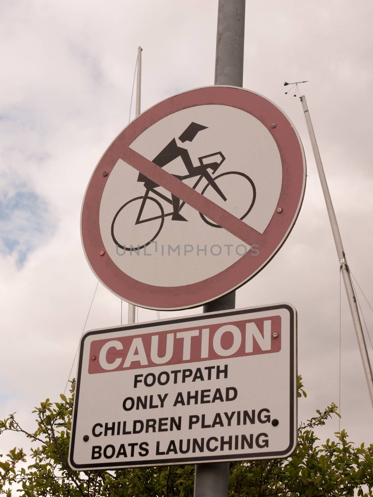 sign outside caution no biking red circle crossed footpath only ahead children playing boats launching outside metal