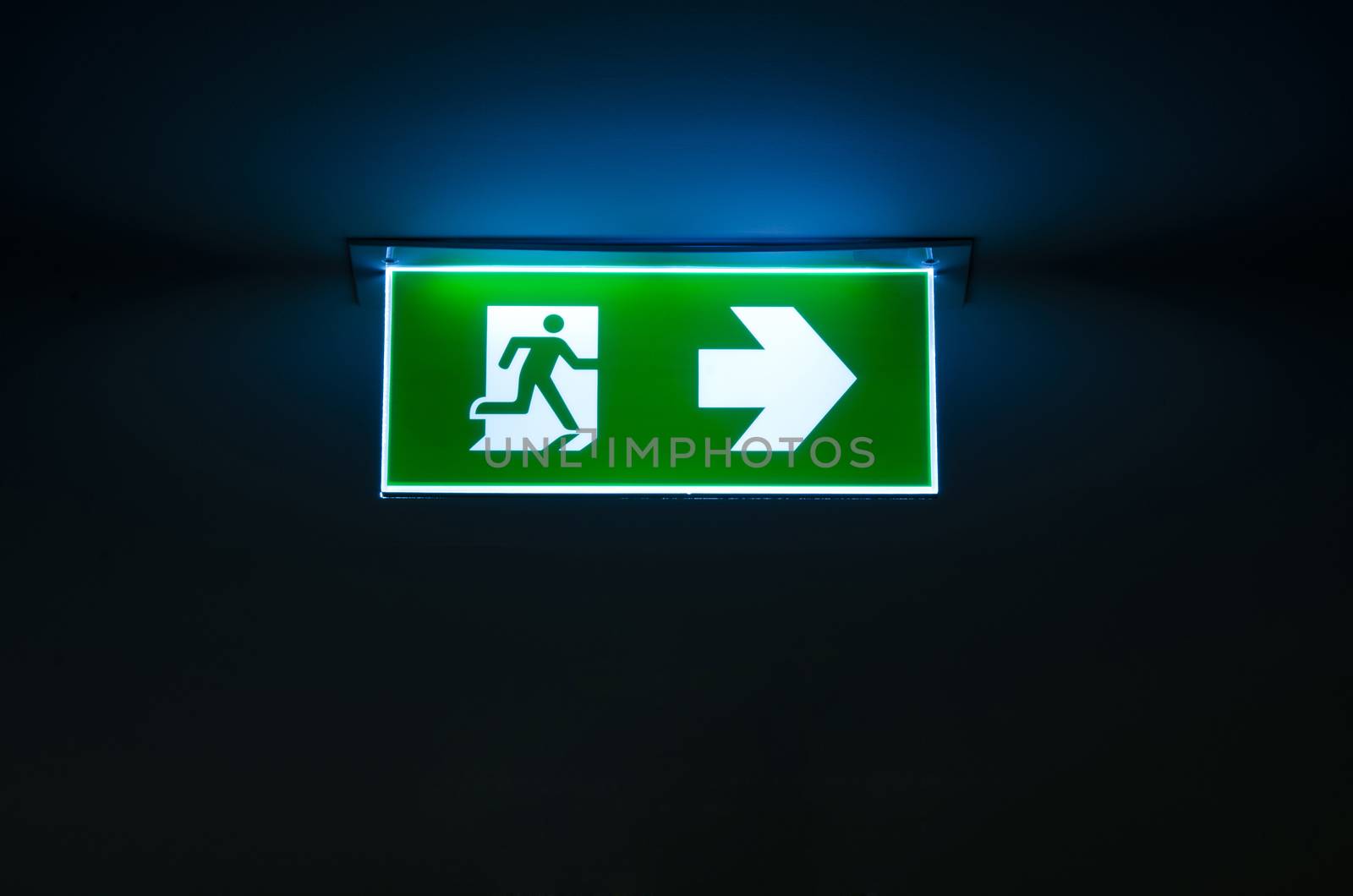 green emergency exit sign the way to escape by phochi