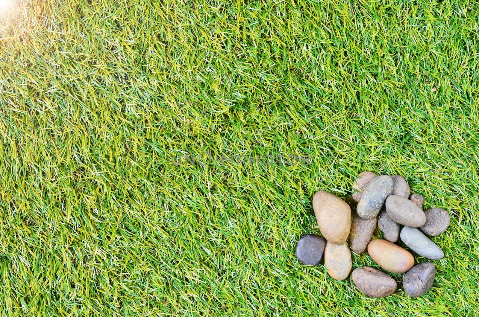 small stone on grass background