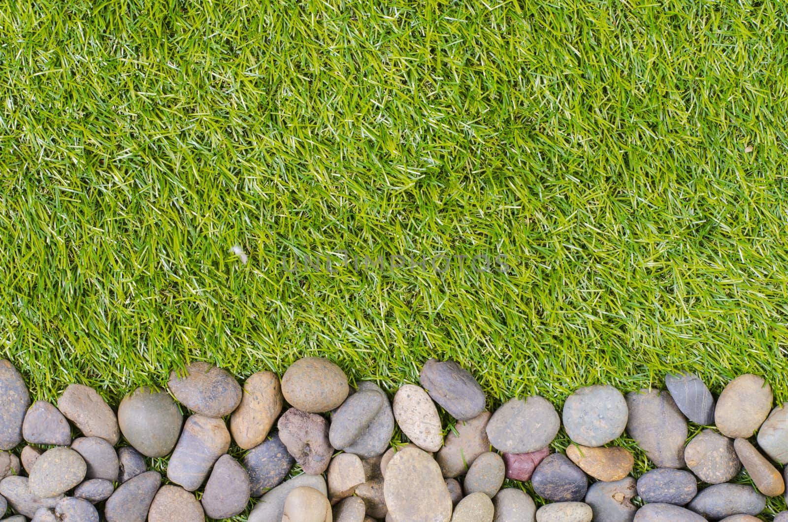 small stone on grass background