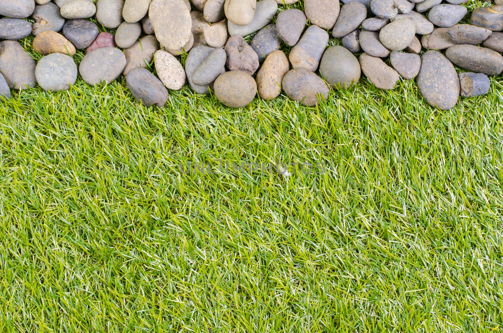 small stone on grass background