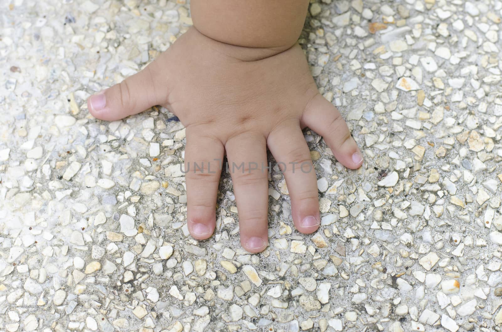 children hand on Gravel background
