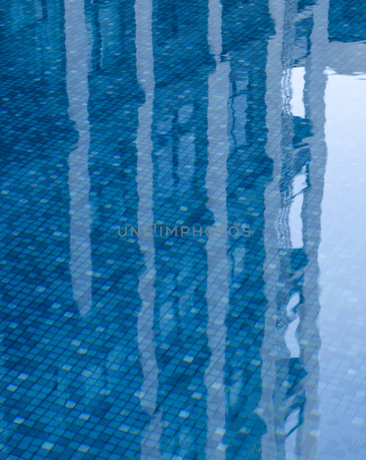 Reflections of building in the calm swimming pool  by phochi