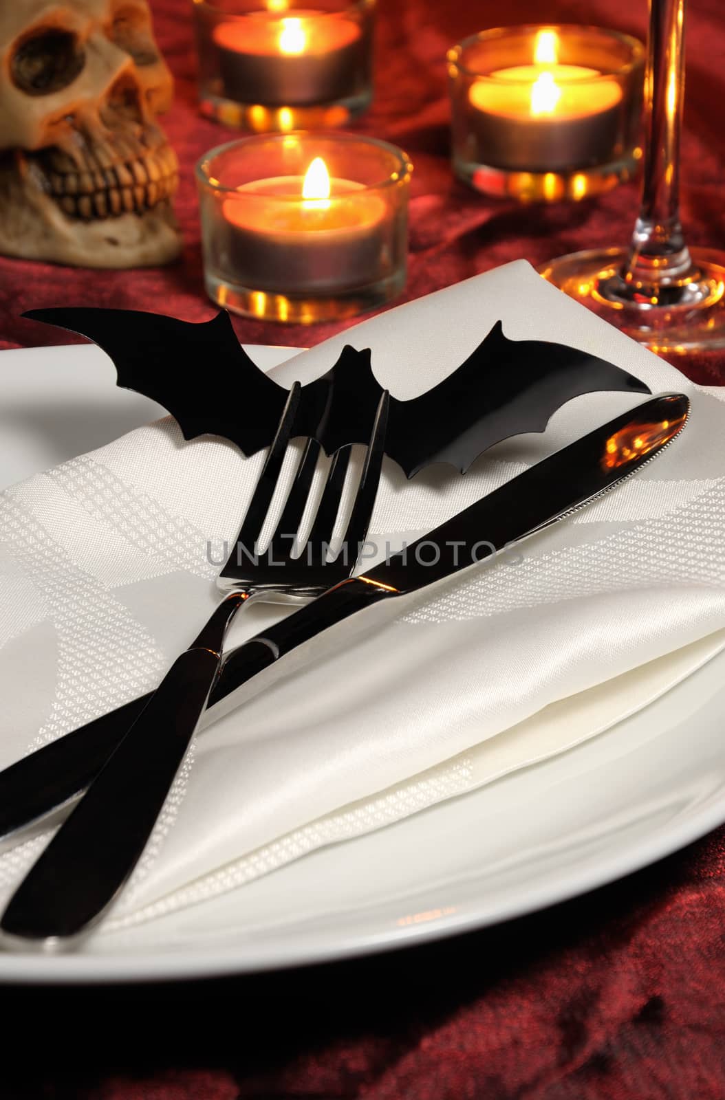 Knife and fork decorated with a bat on a napkin on Halloween as an element of the table serving
