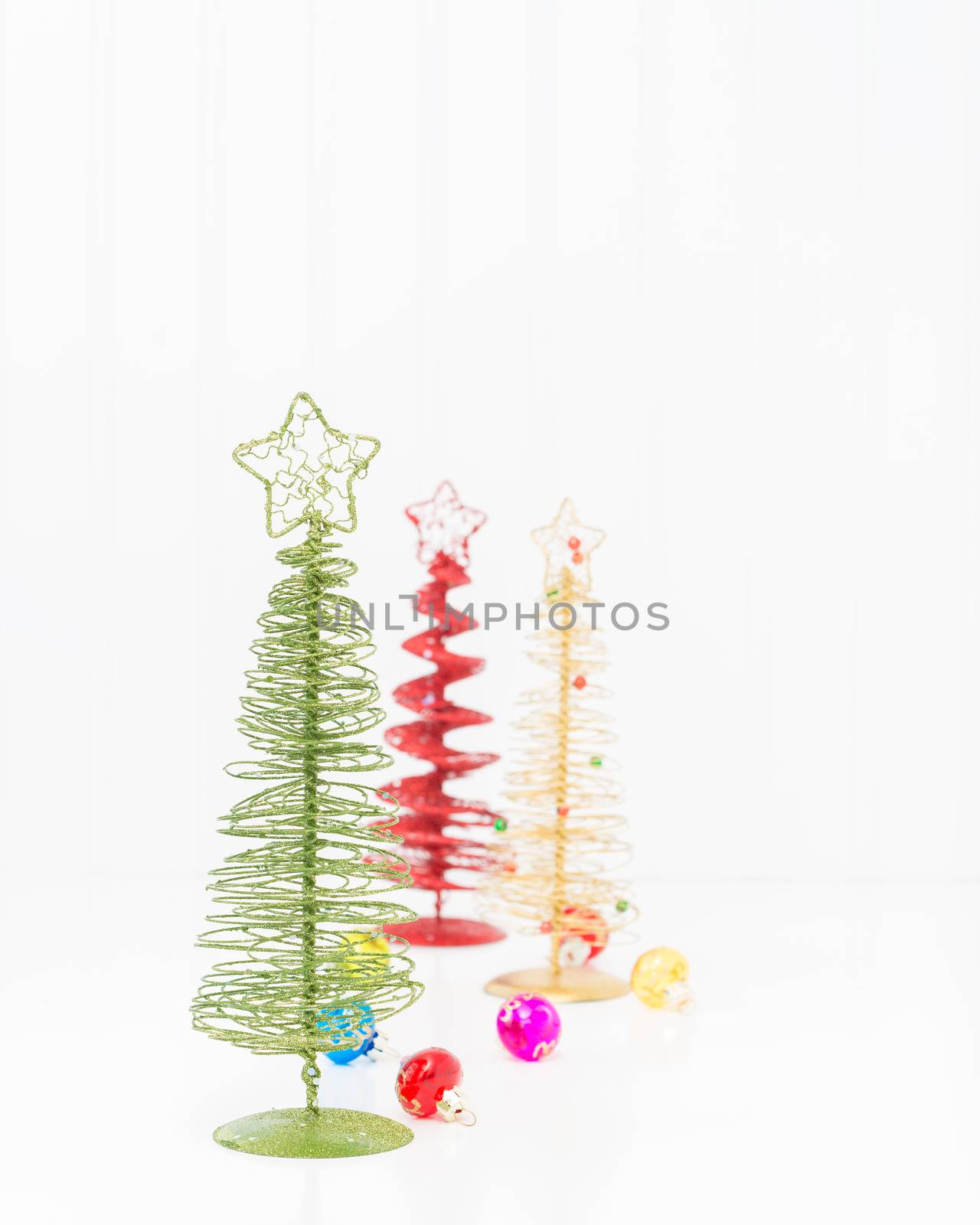 Three colorful stylized christmas trees with ample copy space.