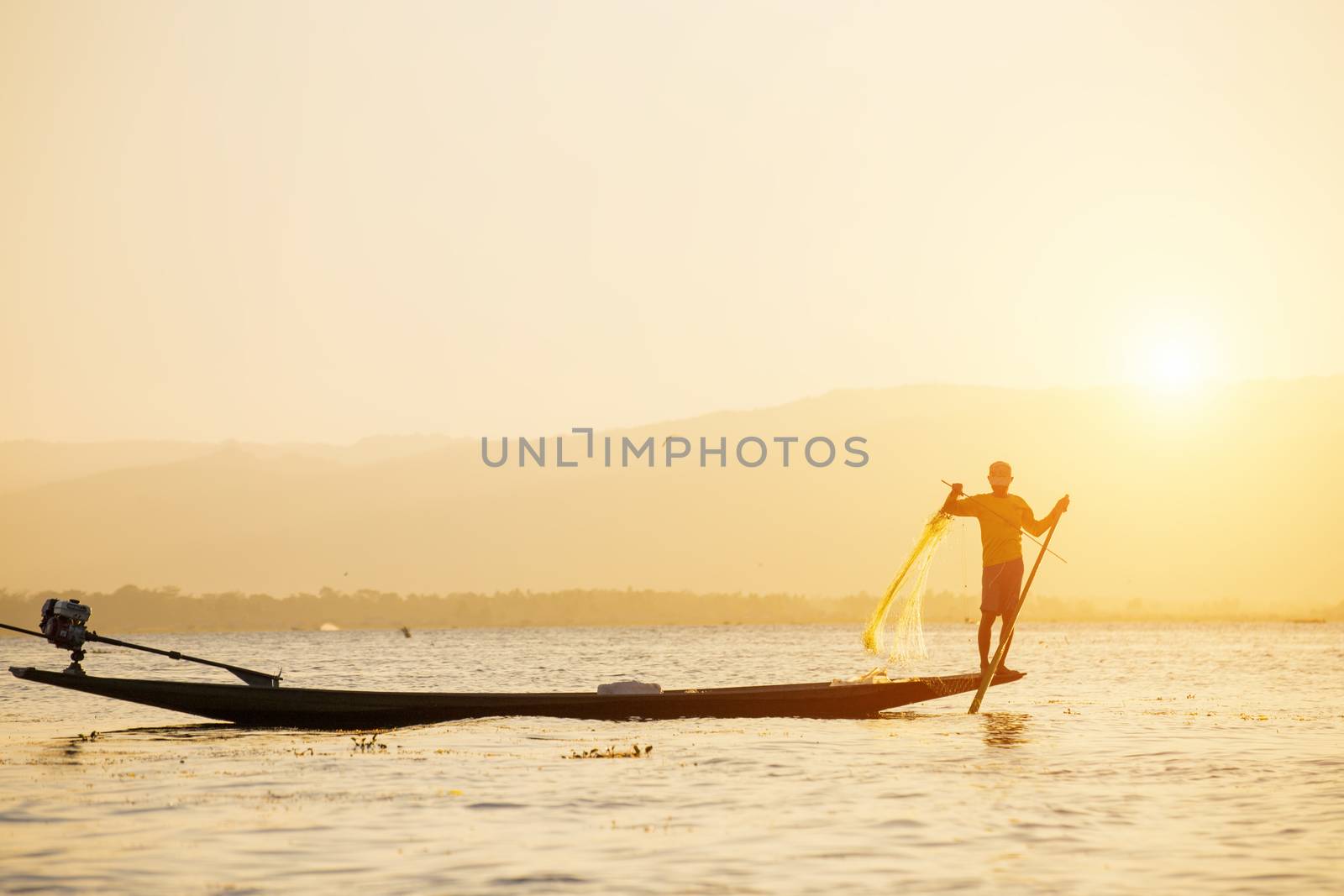 Fisherman of Lake in action when fishing by cozyta