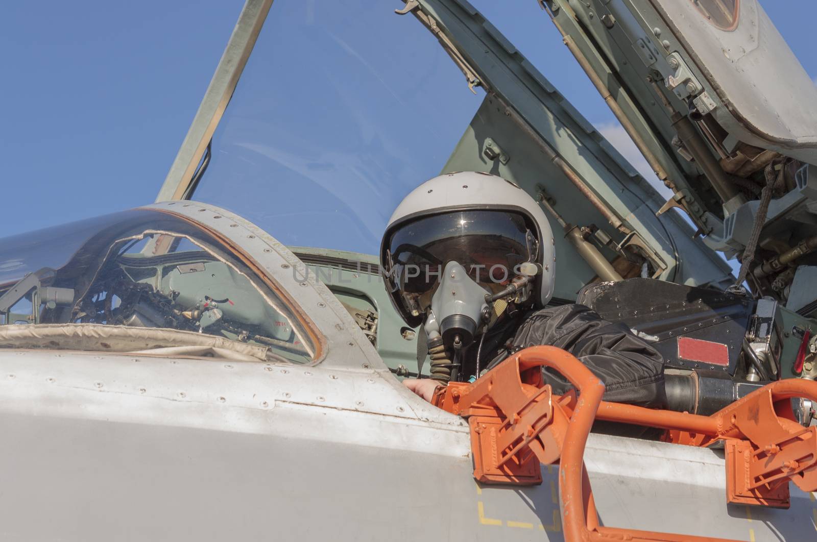Military pilot in the cockpit of a jet aircraft by aarrows