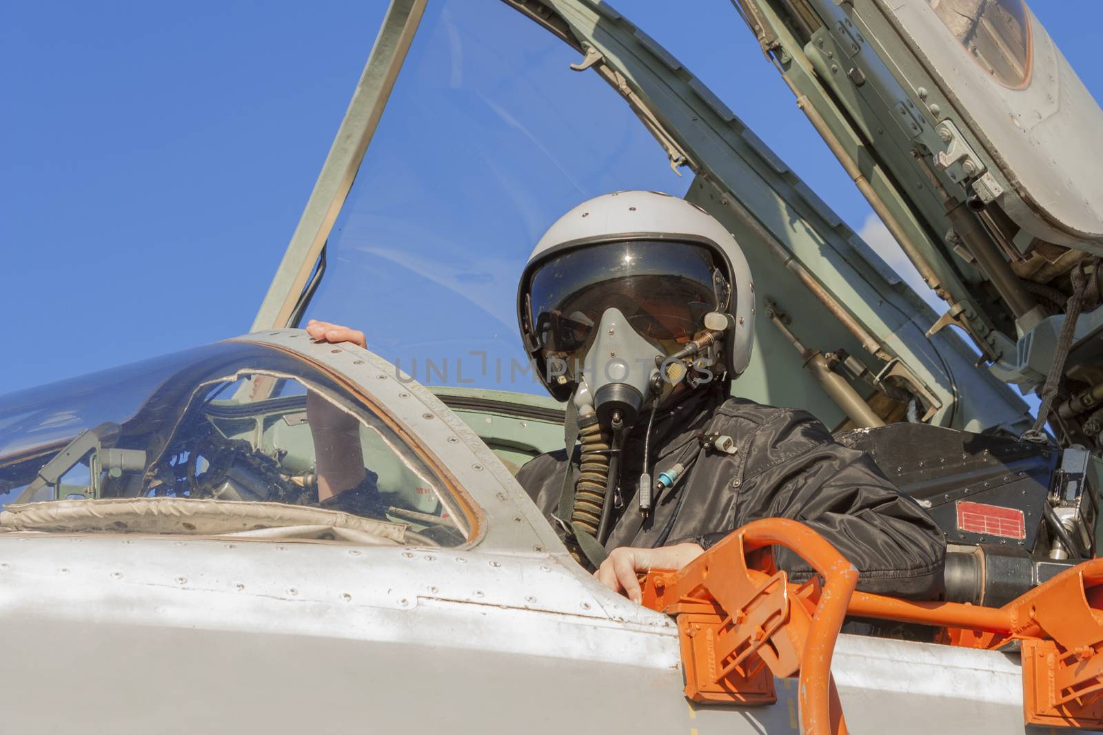 Military pilot in the cockpit of a jet aircraft by aarrows