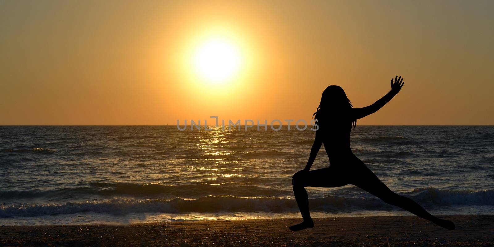 Woman silhouette in a yoga pose on the beach at sunrise by hibrida13