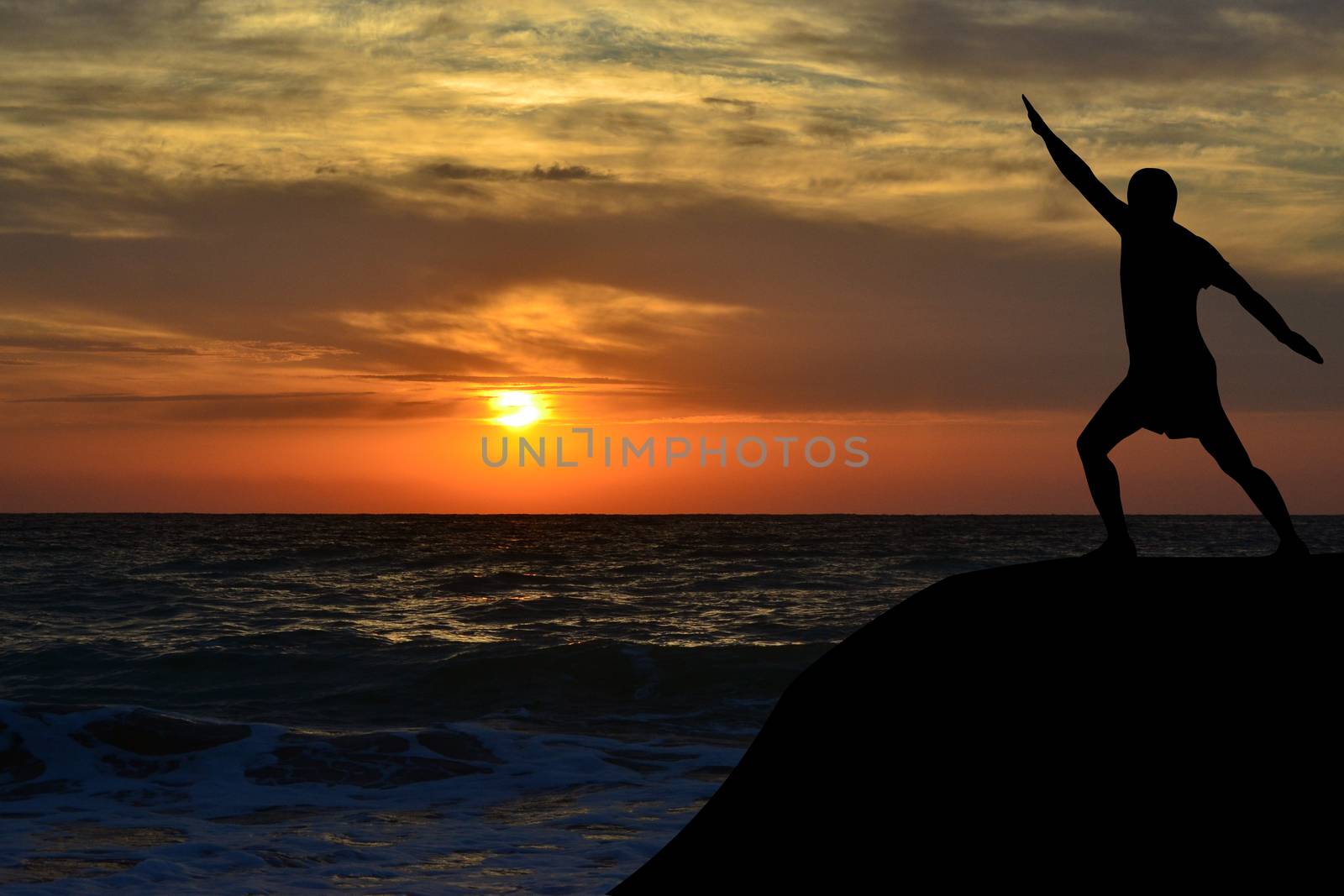 Man silhouette in a yoga pose on the shore at sunrise by hibrida13