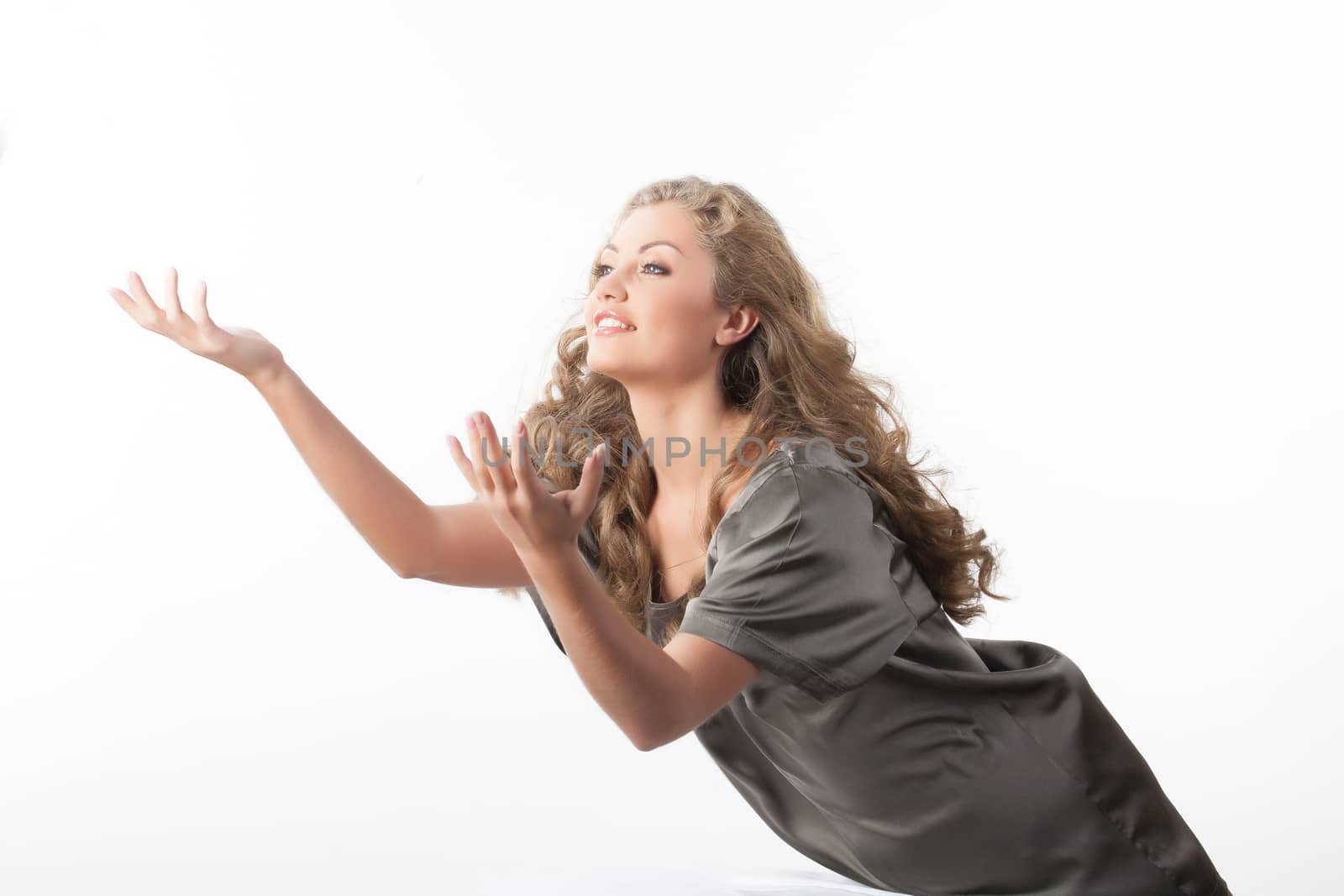 Young smiling beautiful woman on a studio background