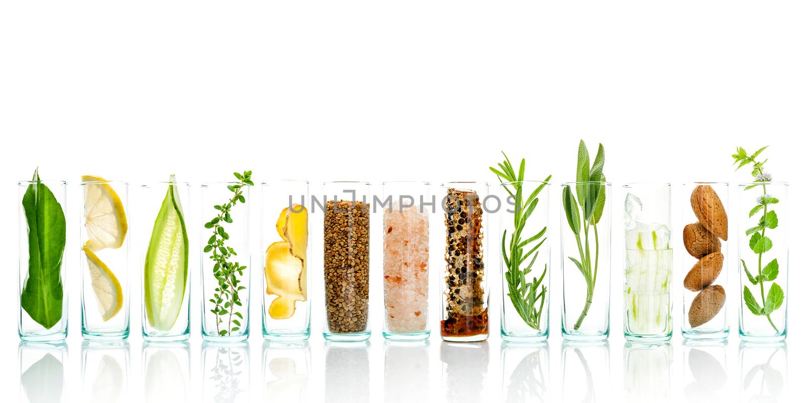 Homemade skin care and body scrubs with natural ingredients aloe vera ,lemon,cucumber ,himalayan salt ,peppermint ,lemon slice,rosemary,almonds,cucumber,ginger and honey pollen isolate on white background.