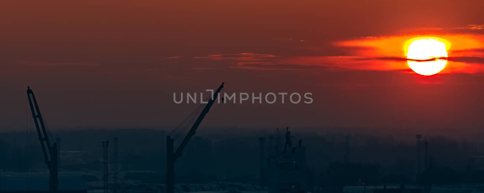 Hot orange sunset over the river. Urban landscape