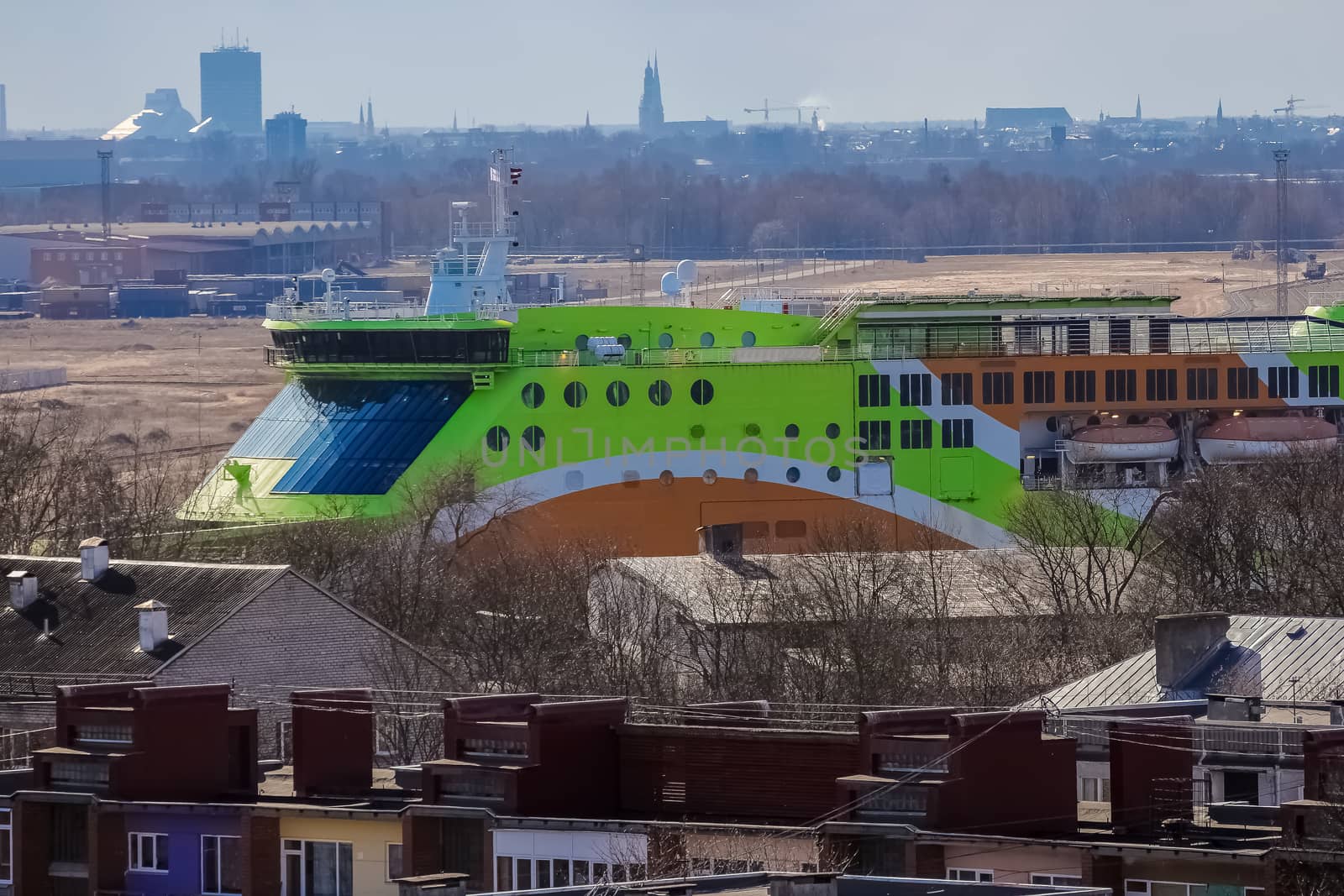 Green cruise liner. Passenger ferry sailing past the Riga city
