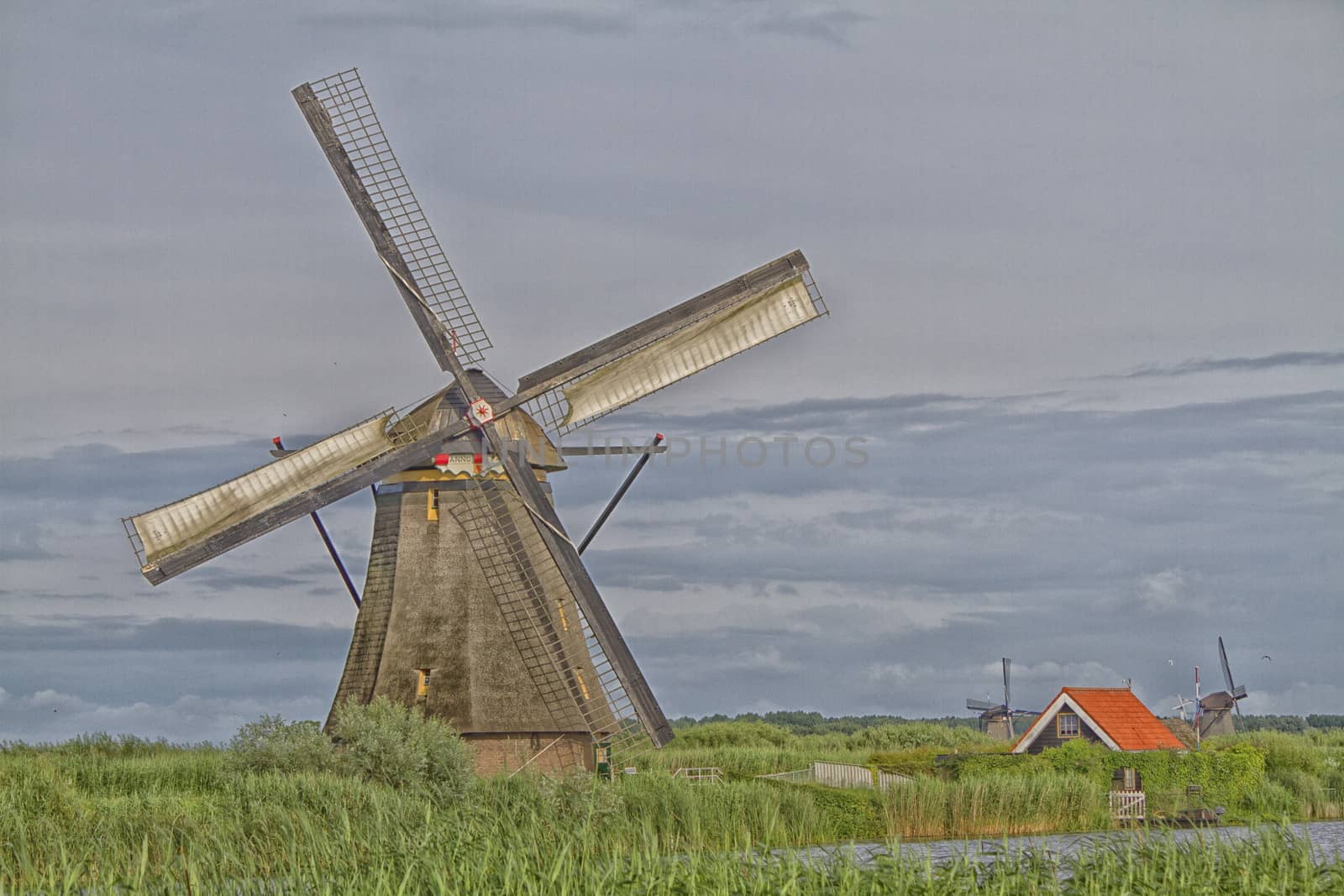 Windmill near the water canal in Netherlands by mariephotos