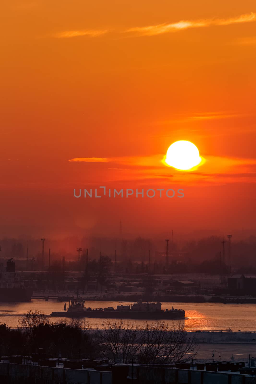 Hot orange sunset over the river. Urban landscape