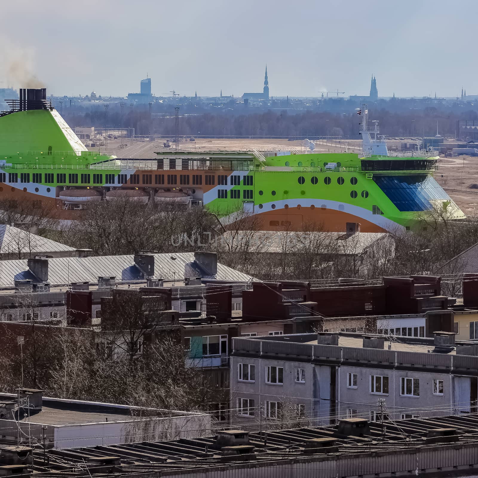 Green cruise liner. Passenger ferry sailing past the Riga city