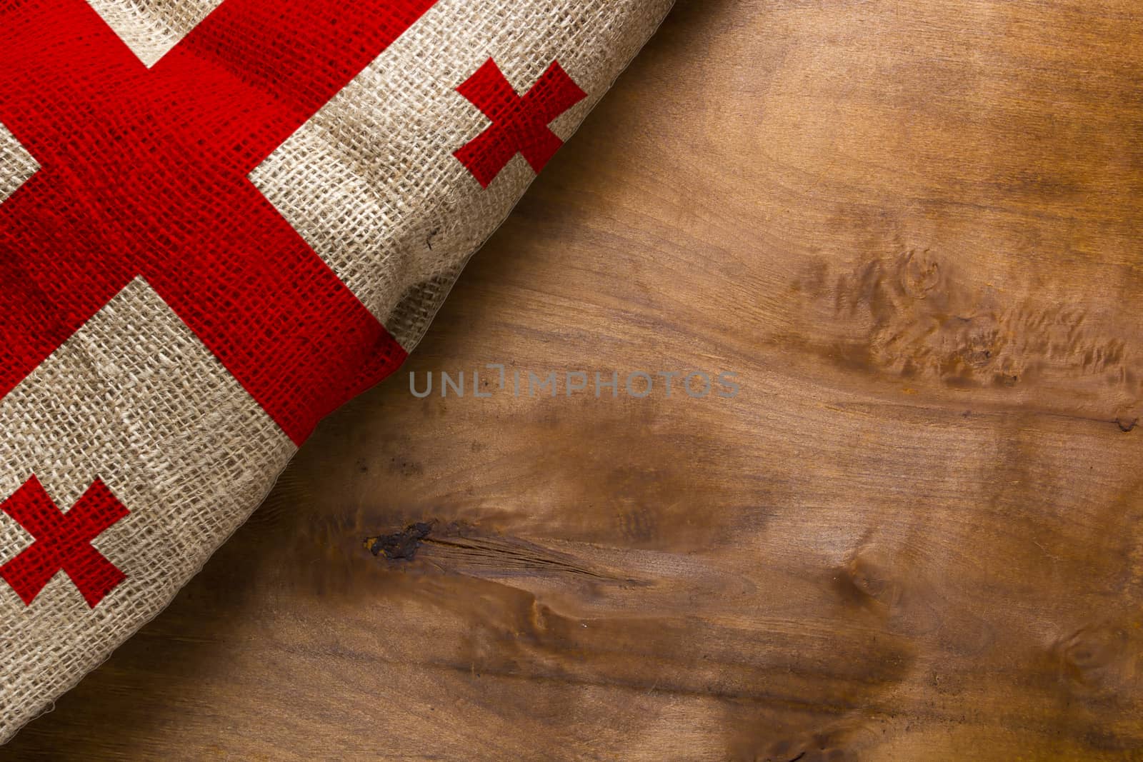 White-red flag of Georgia on a wooden background.