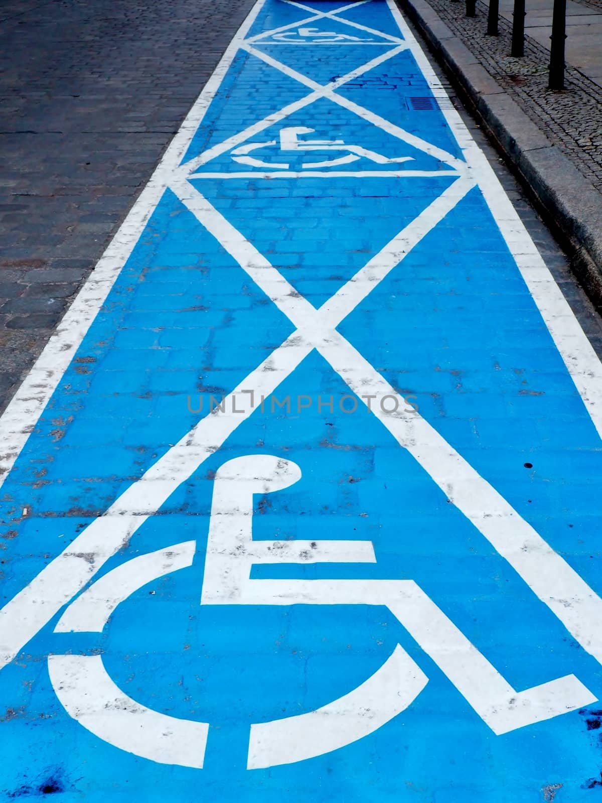 Three parking spaces for disabled people painted on the street.