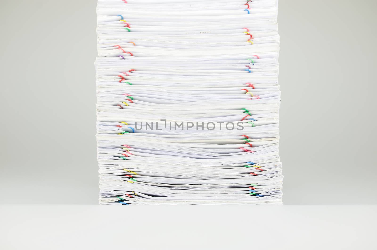 Pile overload document with colorful paperclip on white background by eaglesky