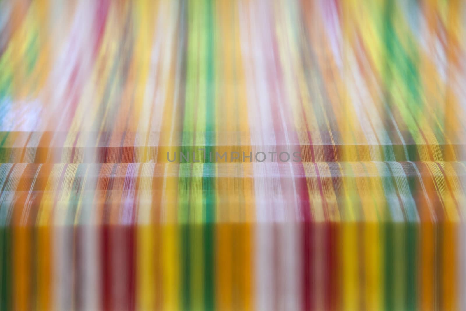Yarn background, old weaving Loom and thread of yarn. A traditional hand-weaving loom being used to make cloth at home.Background surface blurred.(Background blur)