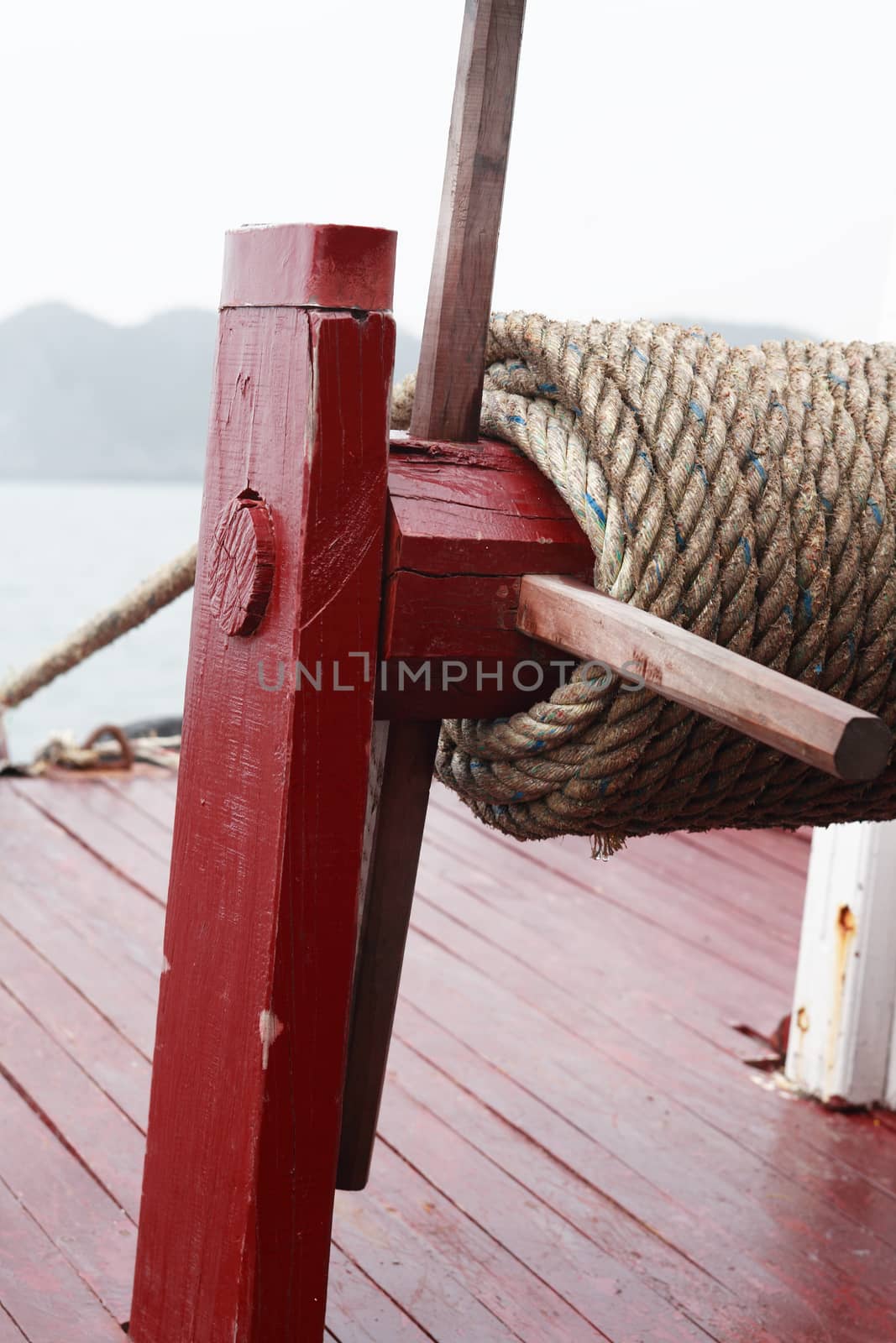 Closeup of fishing boat parking with rope for anchor