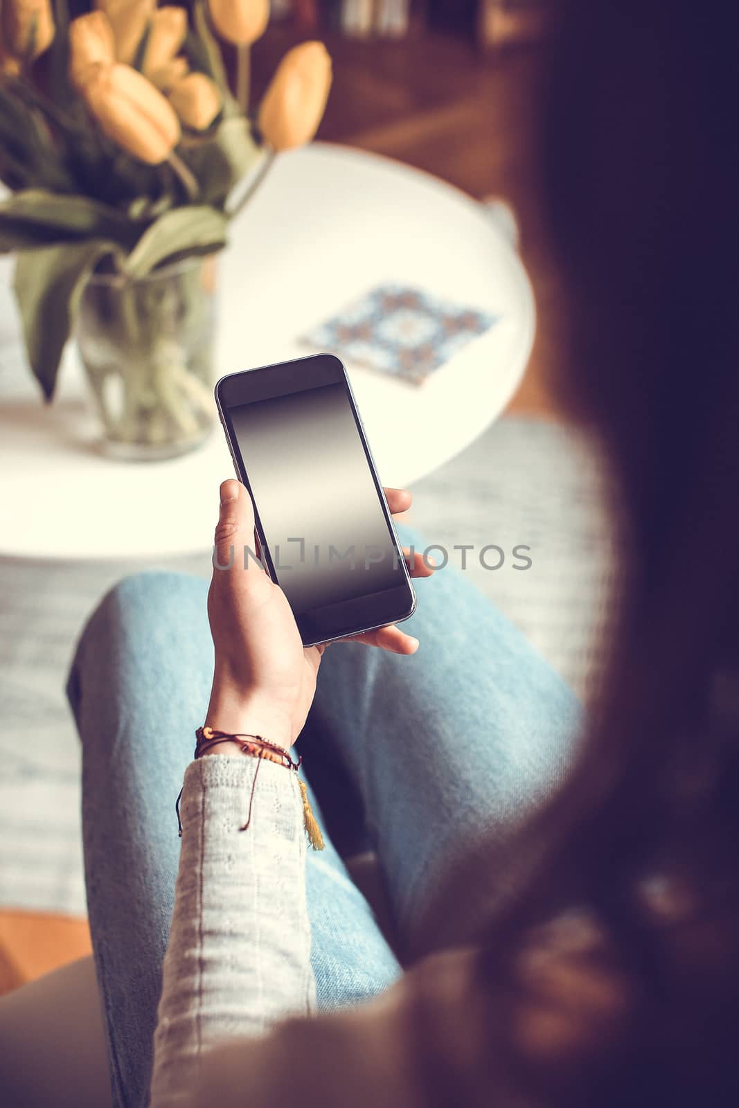 Mobile phone in the hands of a girl with screen