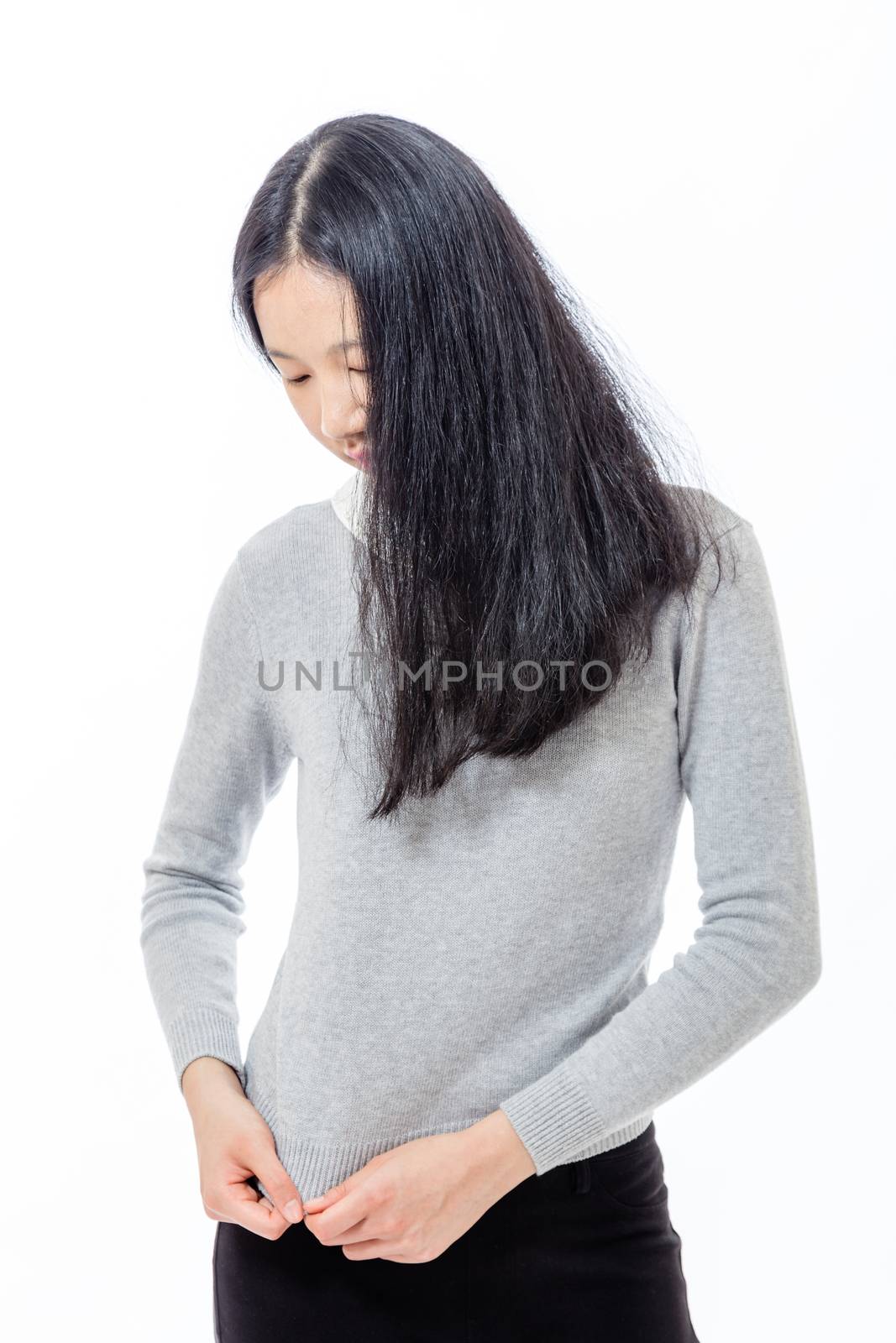 Timid Asian  teenage girl looking down