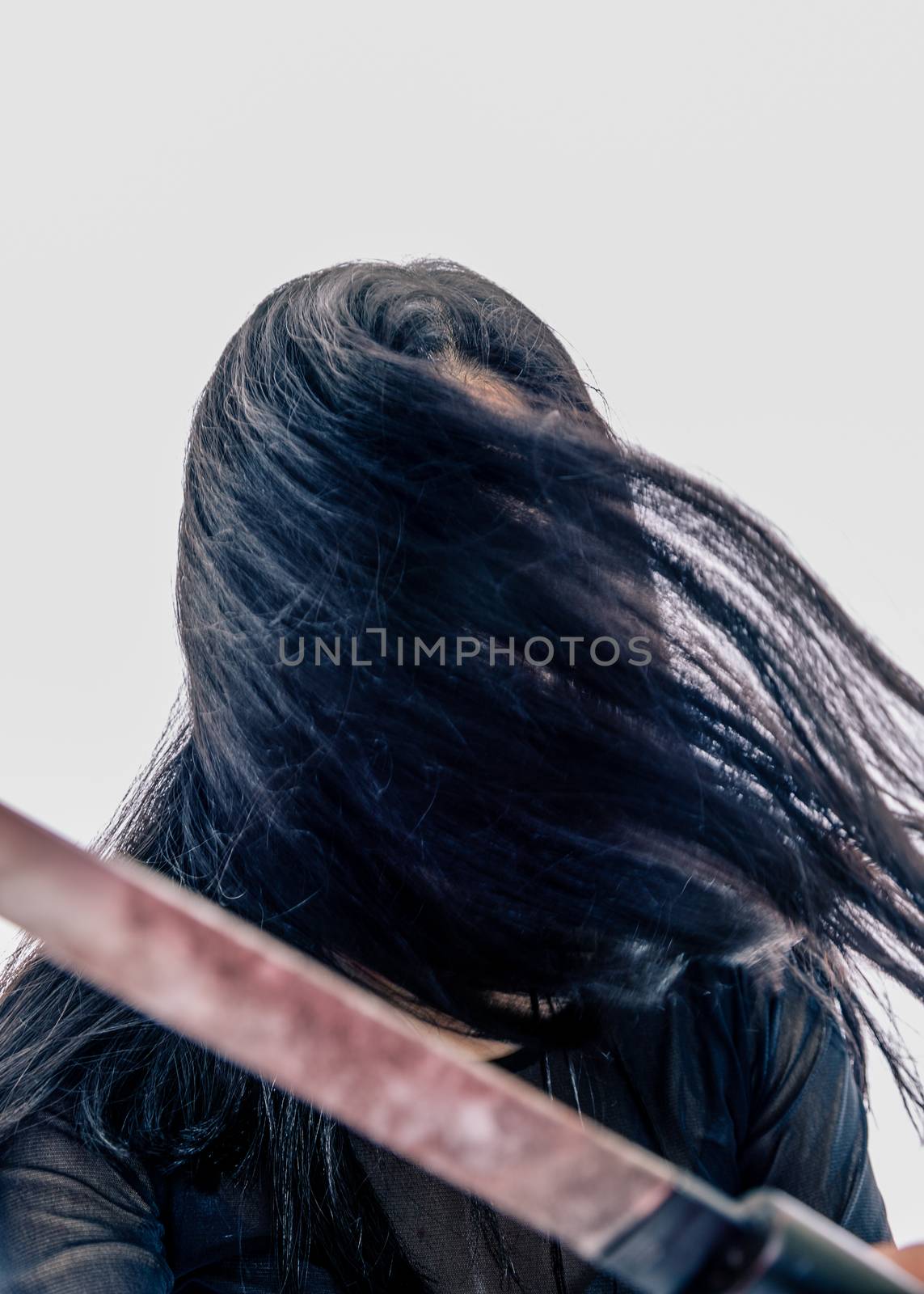 Girl with face hidden by hair holding sword