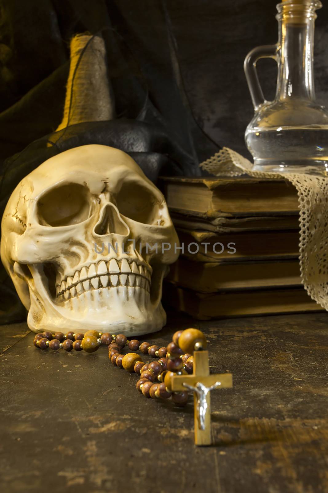 Human skull and ancient books still life