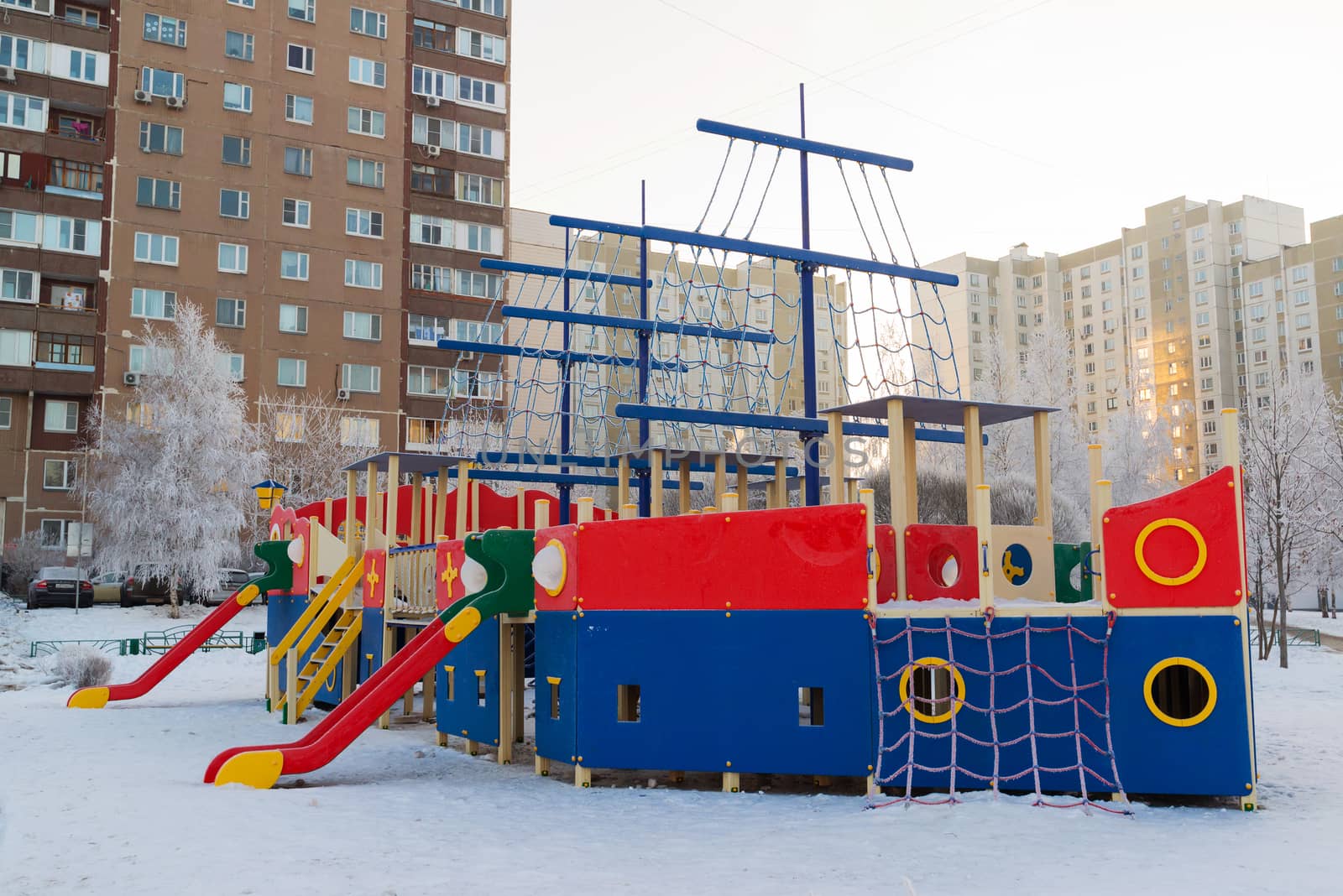 Playground structure outdoors in winter by olgavolodina