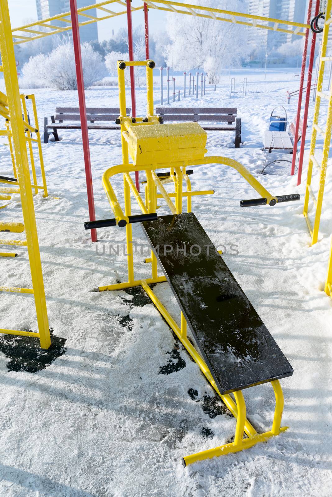 Fitness equipment outdoors in winter by olgavolodina