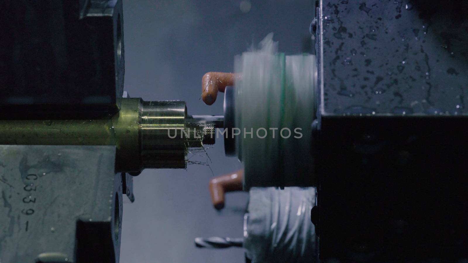 CNC milling machine makes some steel part by Chudakov